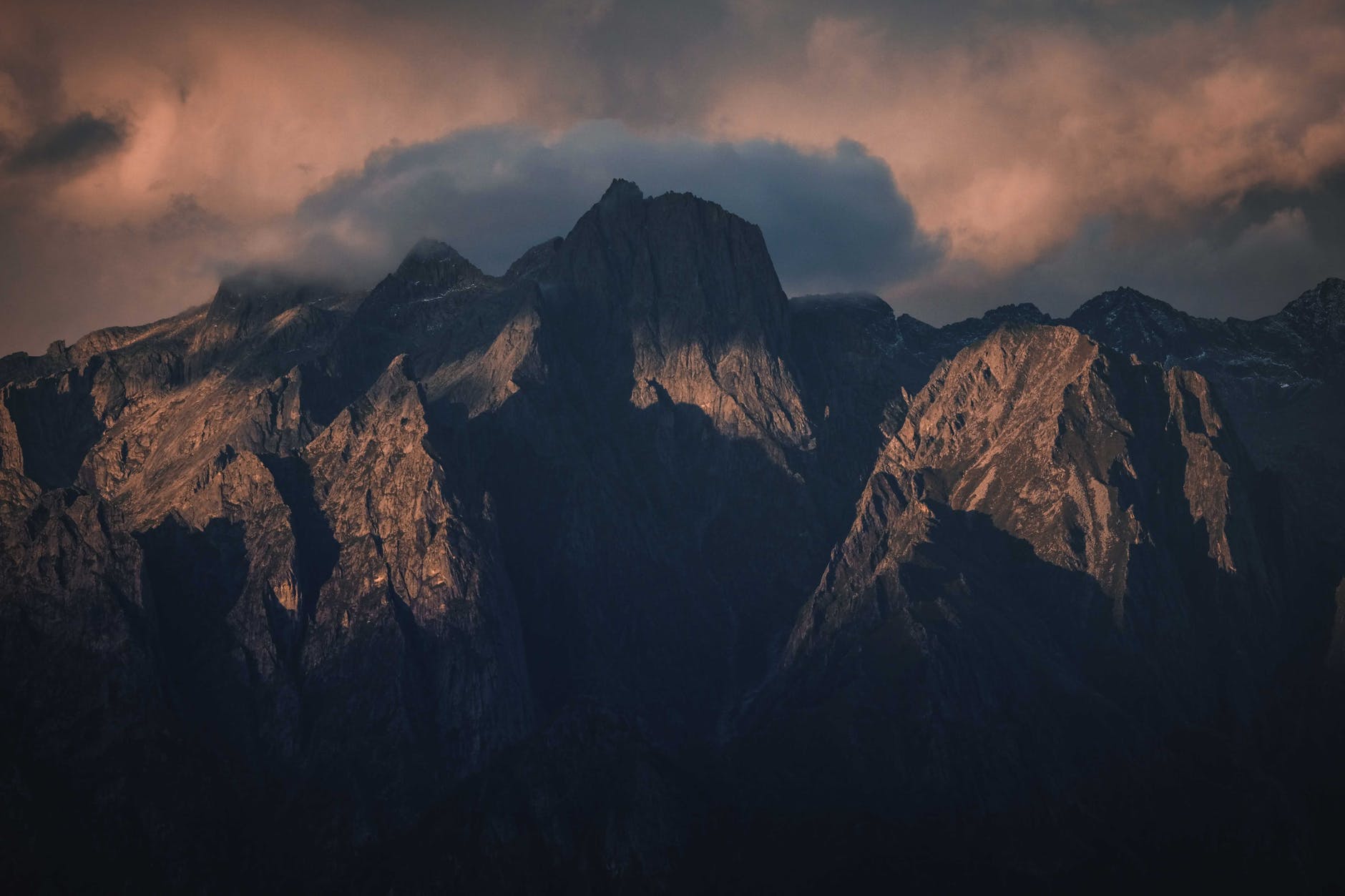 rocky mountains against cloudy sky