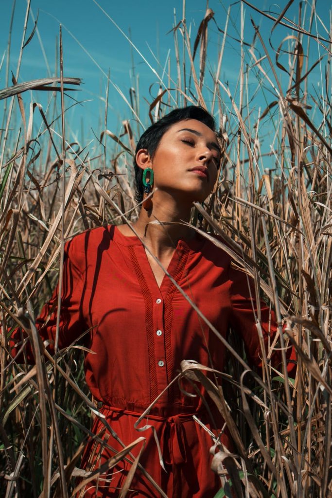 stylish woman standing in field