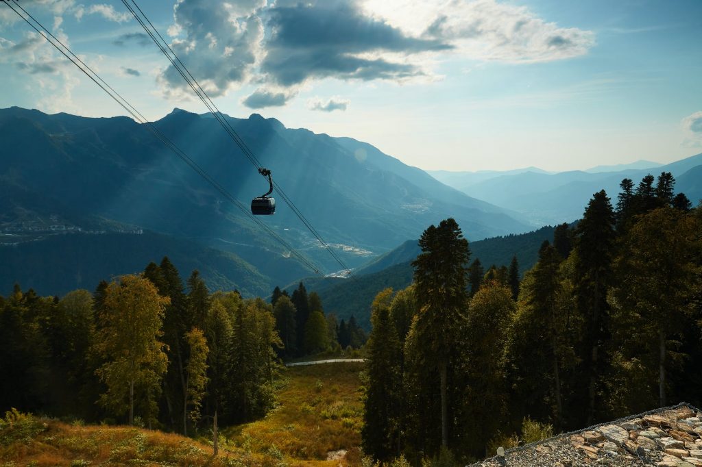 cable car over green forested hills