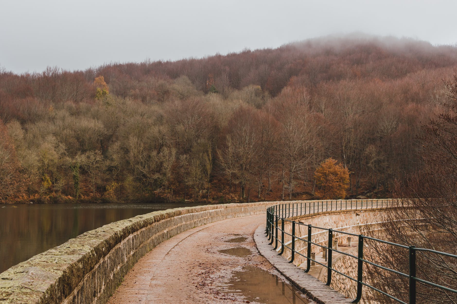 footbridge with stone facade over water