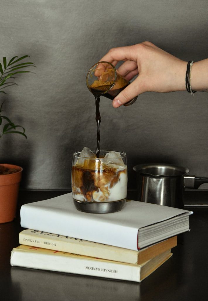 photo of person pouring coffee