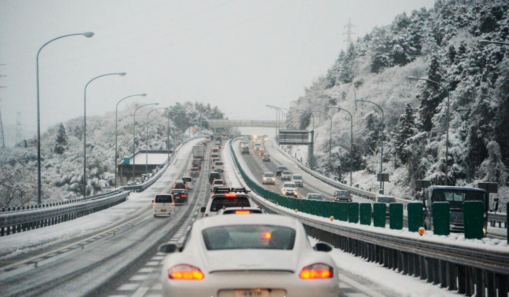 winter traffic on snowy highway with cars