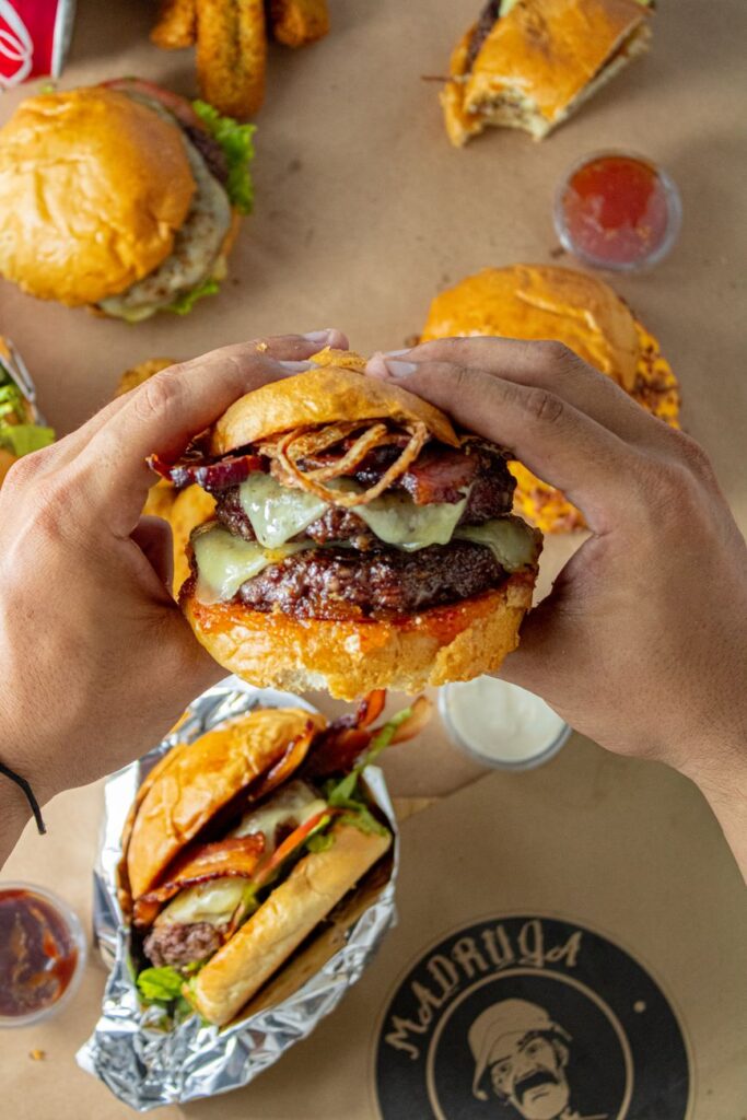 hands holding juicy burger